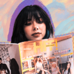 Carolina Steiner with a paper copy of HIT! Magazine